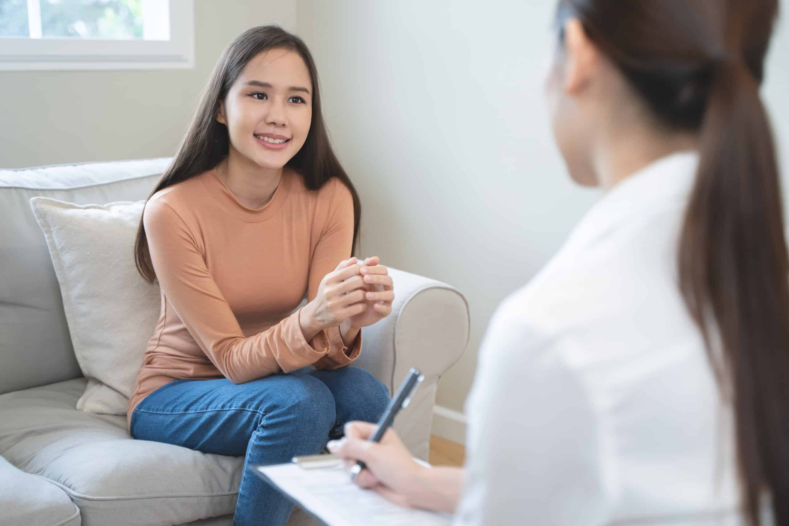 Mental health counselor. Young woman during therapy session talking with a psychologist in the office.