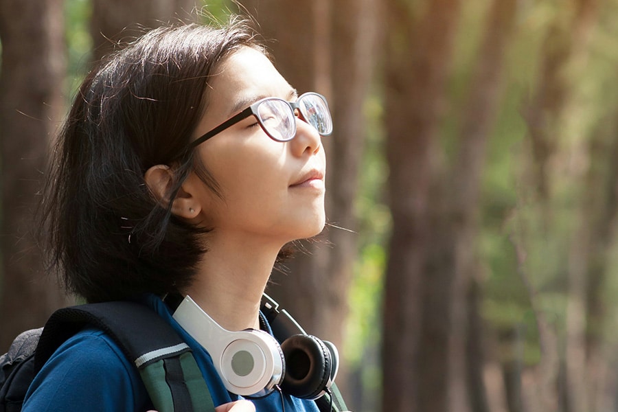 a woman with headphones around her neck