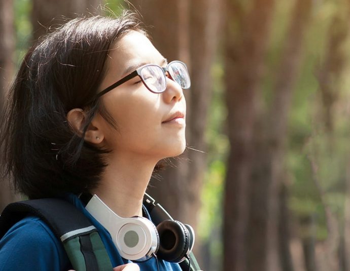 a woman with headphones around her neck